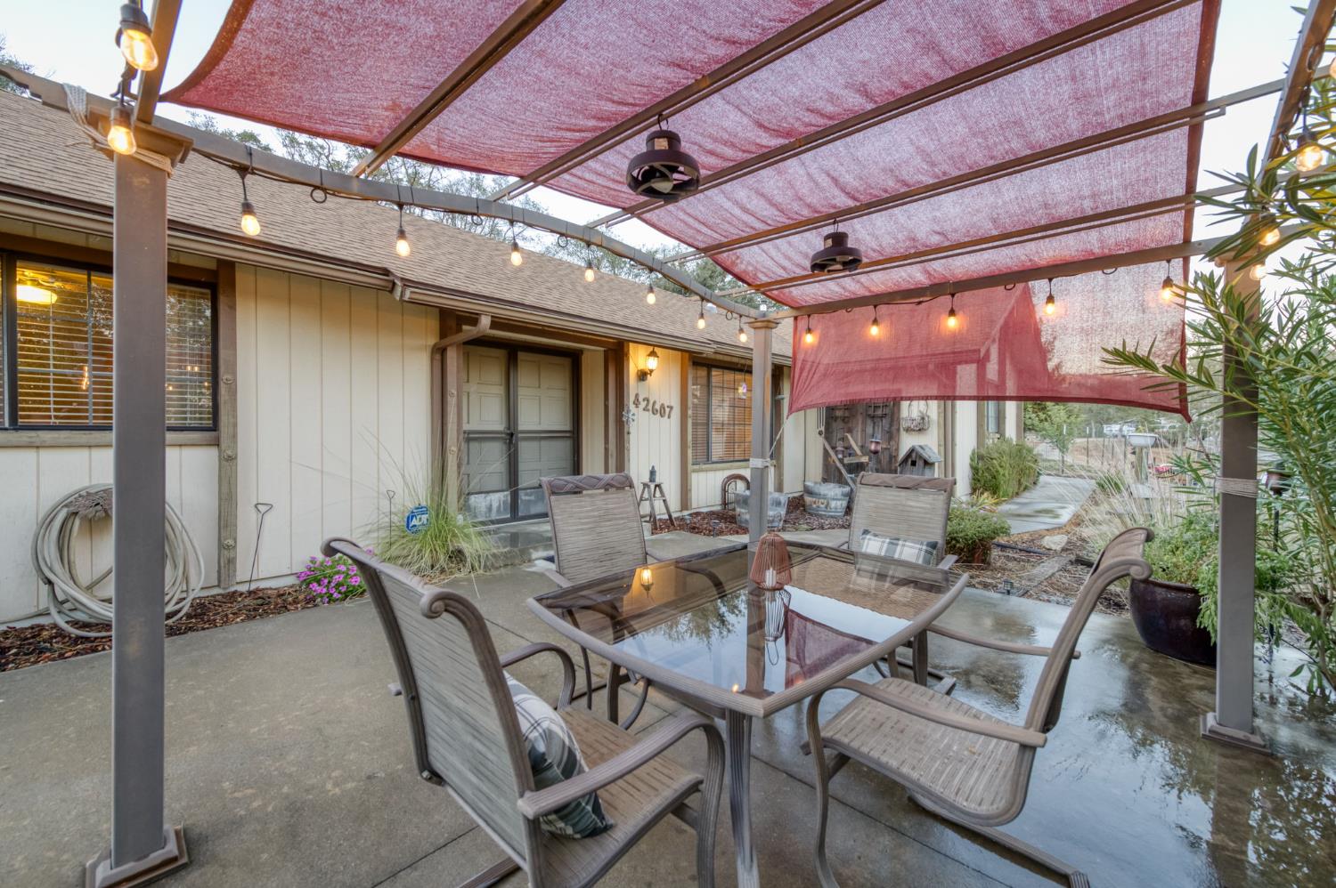 42607 Long Hollow Drive Coarsegold, CA 93614 - Photo 52 of 52 a view of a patio with a table and chairs and a barbeque