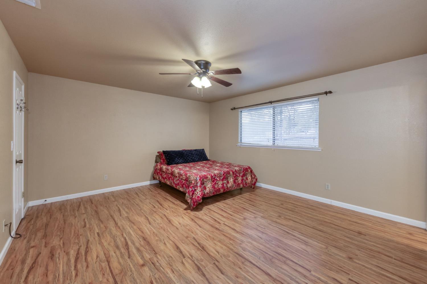 42607 Long Hollow Drive Coarsegold, CA 93614 - Photo 6 of 52 a bedroom with a bed and wooden floor