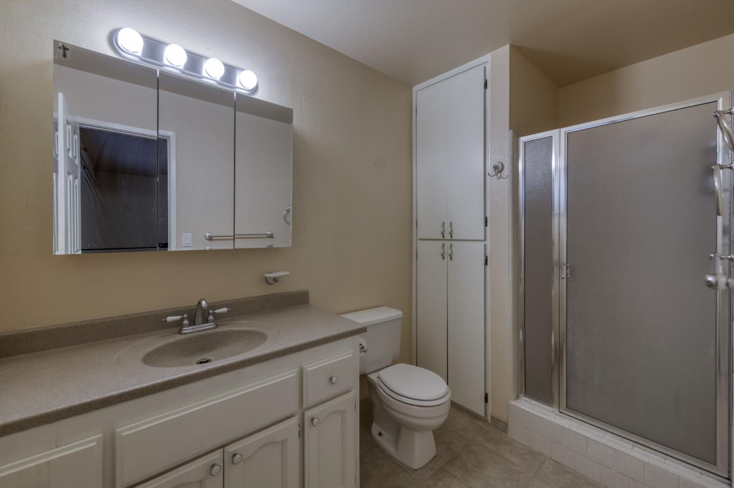 42607 Long Hollow Drive Coarsegold, CA 93614 - Photo 9 of 52 a bathroom with a granite countertop sink a toilet and shower
