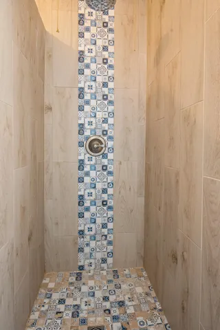 a bathroom with a shower and a sink