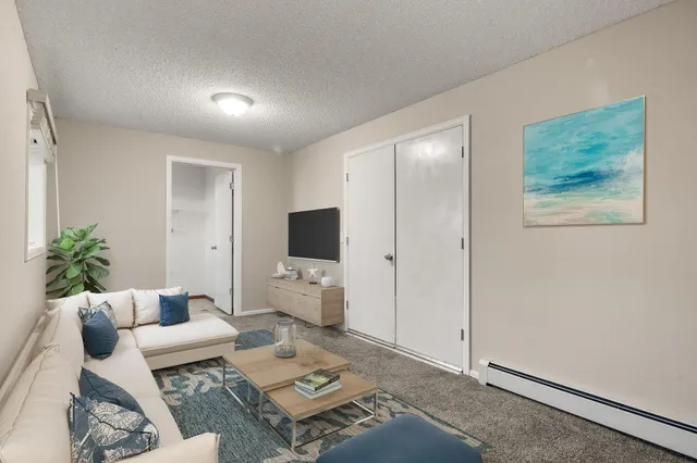 a living room with furniture and a flat screen tv