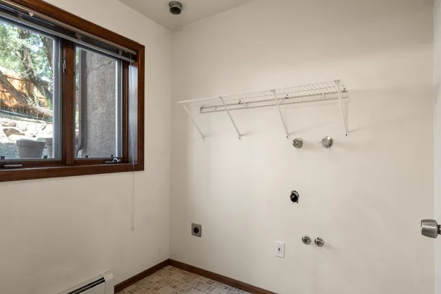 a view of a small space with wooden floor and windows