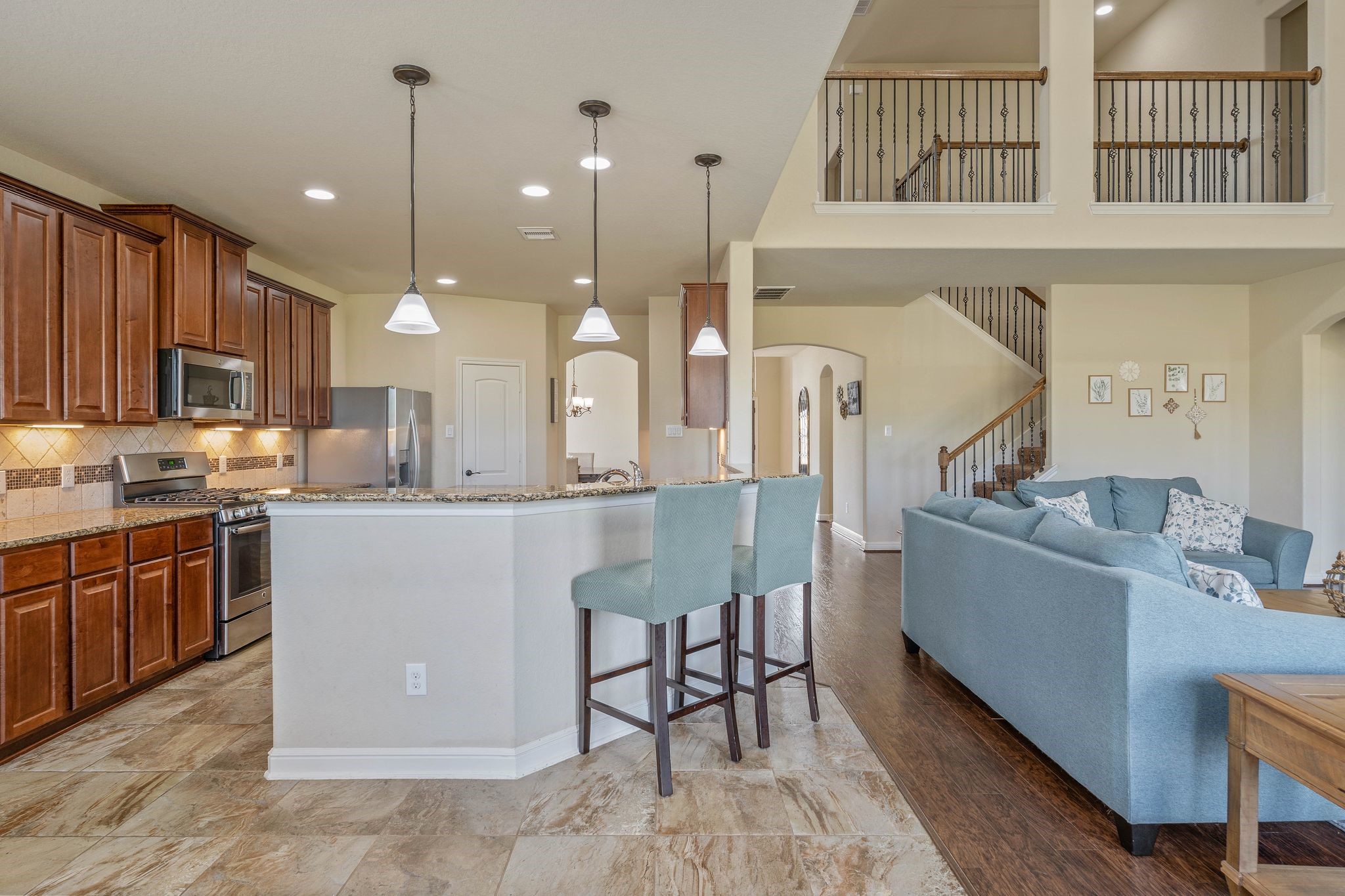 10114 North Whimbrel Circle Conroe, TX 77385 - Photo 13 of 50 a large kitchen with kitchen island a island a stove a sink dishwasher a dining table and chairs with wooden floor