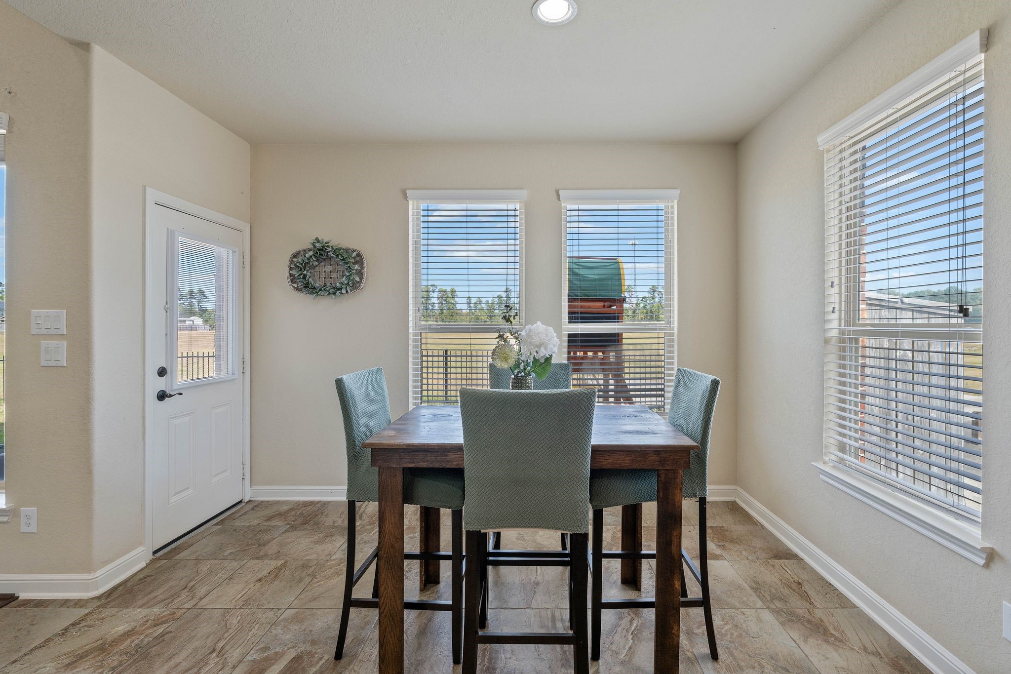 10114 North Whimbrel Circle Conroe, TX 77385 - Photo 19 of 50 a view of a dining room with furniture window and wooden floor