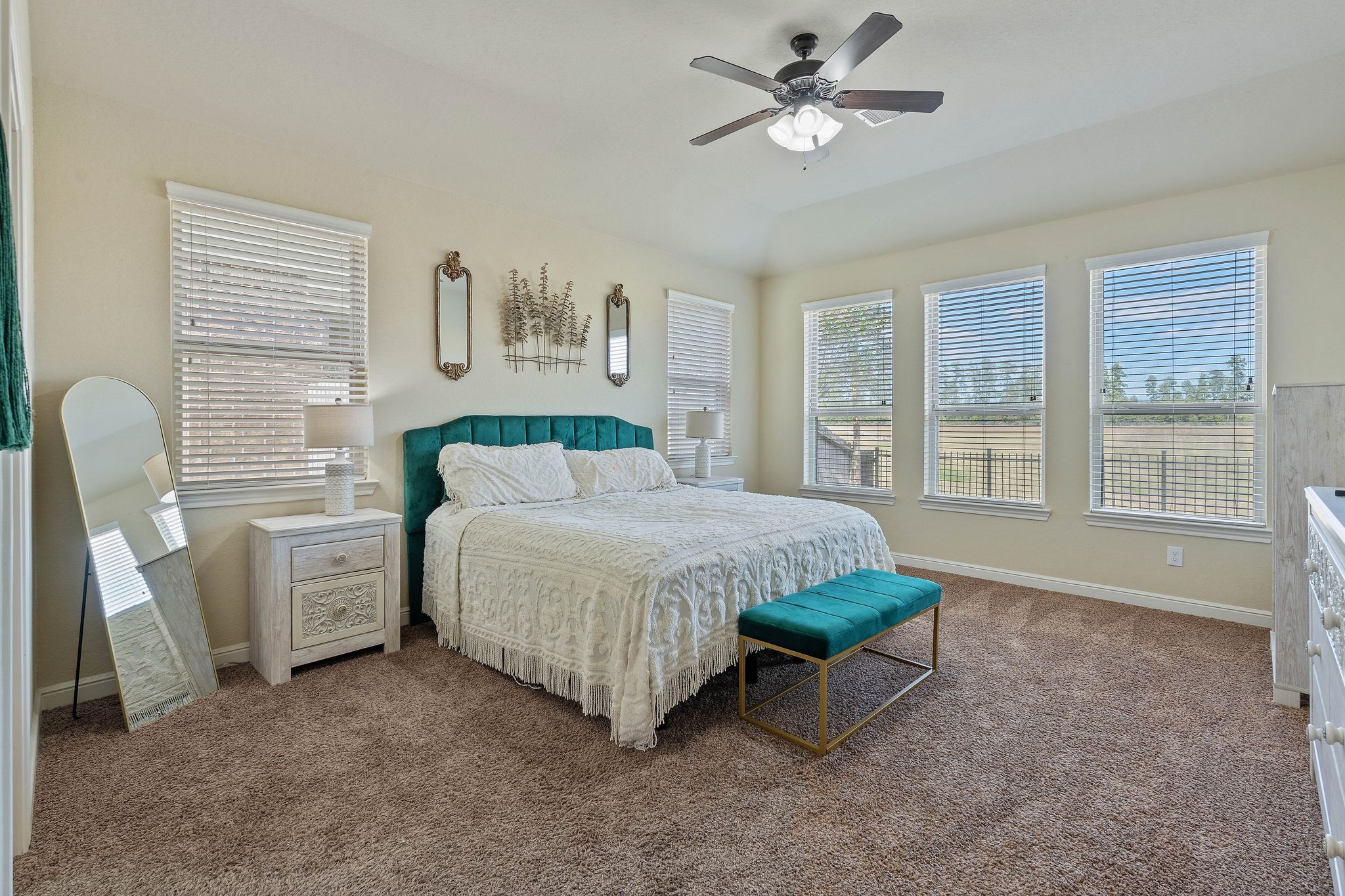 10114 North Whimbrel Circle Conroe, TX 77385 - Photo 20 of 50 a spacious bedroom with a large bed and a chandelier