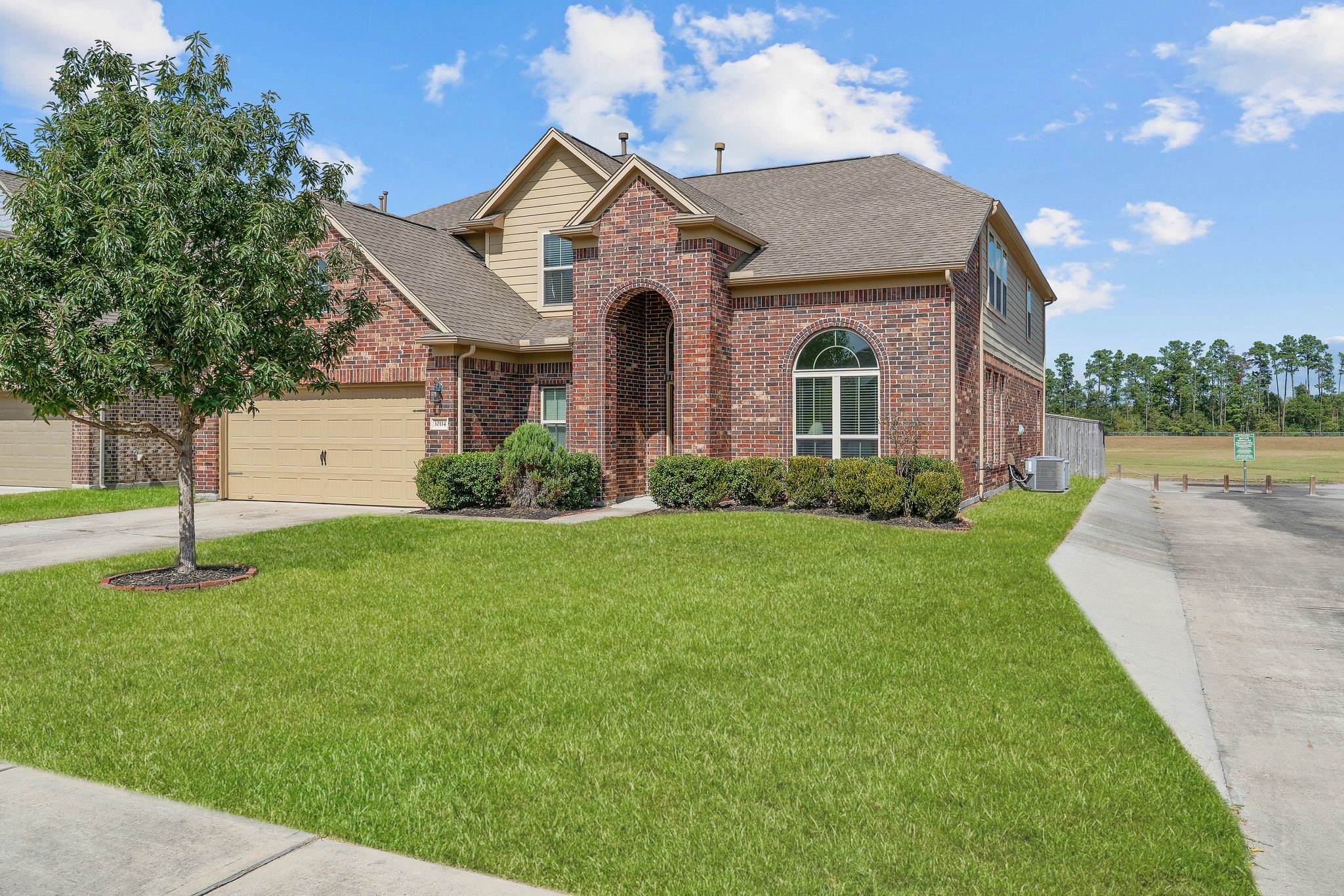 10114 North Whimbrel Circle Conroe, TX 77385 - Photo 2 of 50 a front view of a house with a yard