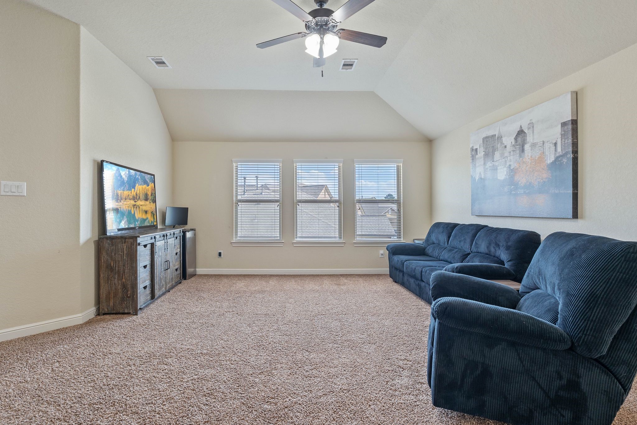 10114 North Whimbrel Circle Conroe, TX 77385 - Photo 38 of 50 a living room with furniture and a flat screen tv
