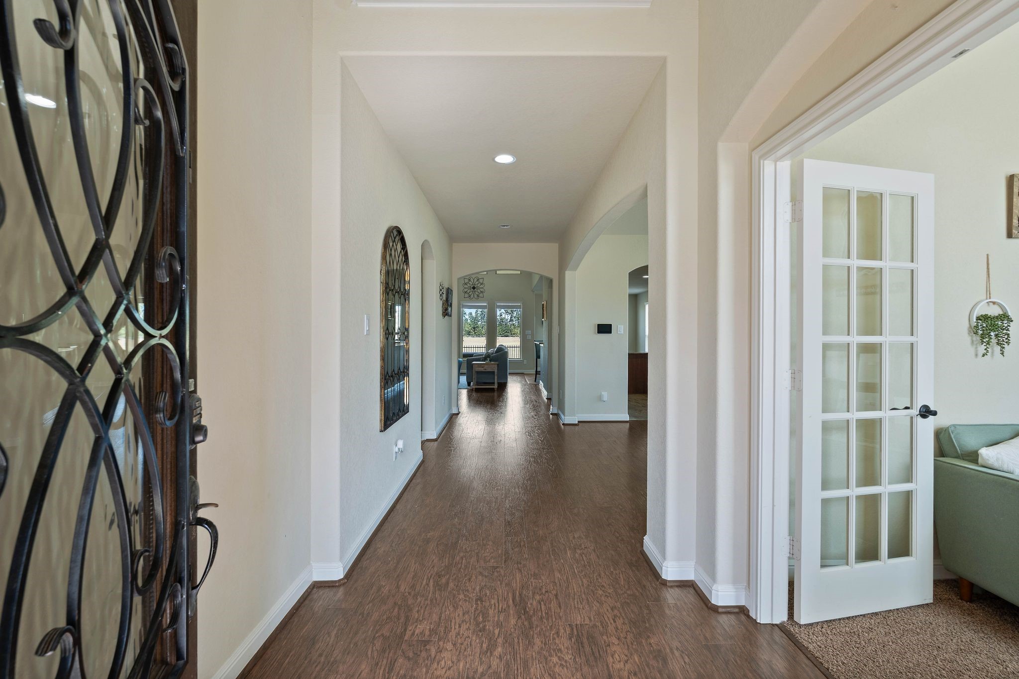 10114 North Whimbrel Circle Conroe, TX 77385 - Photo 4 of 50 a view of a hallway with wooden floor and a living room