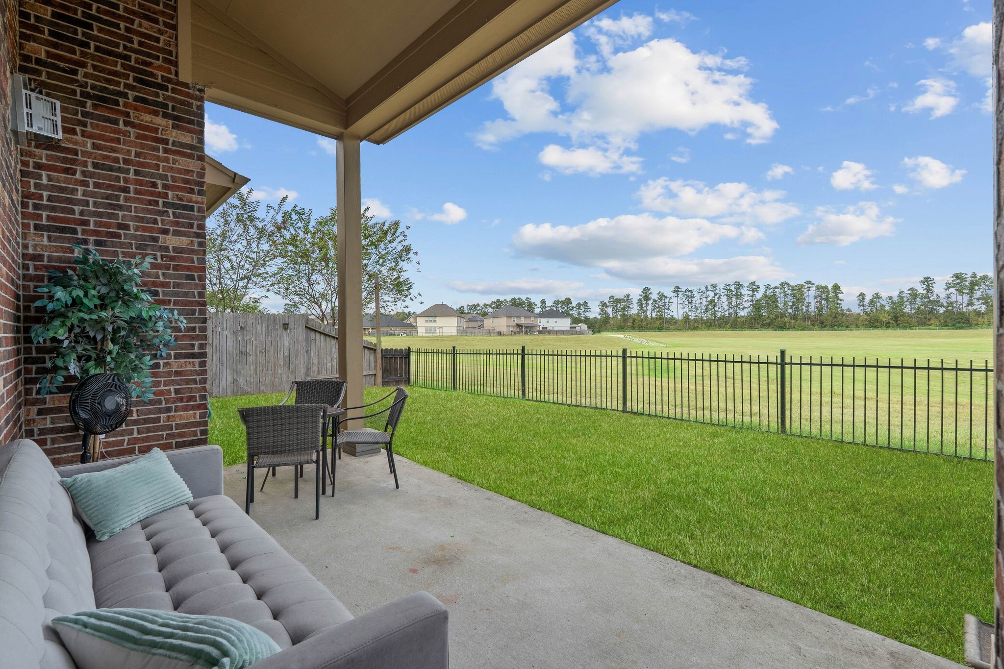 10114 North Whimbrel Circle Conroe, TX 77385 - Photo 42 of 50 a view of a patio with dining table and chairs with a yard