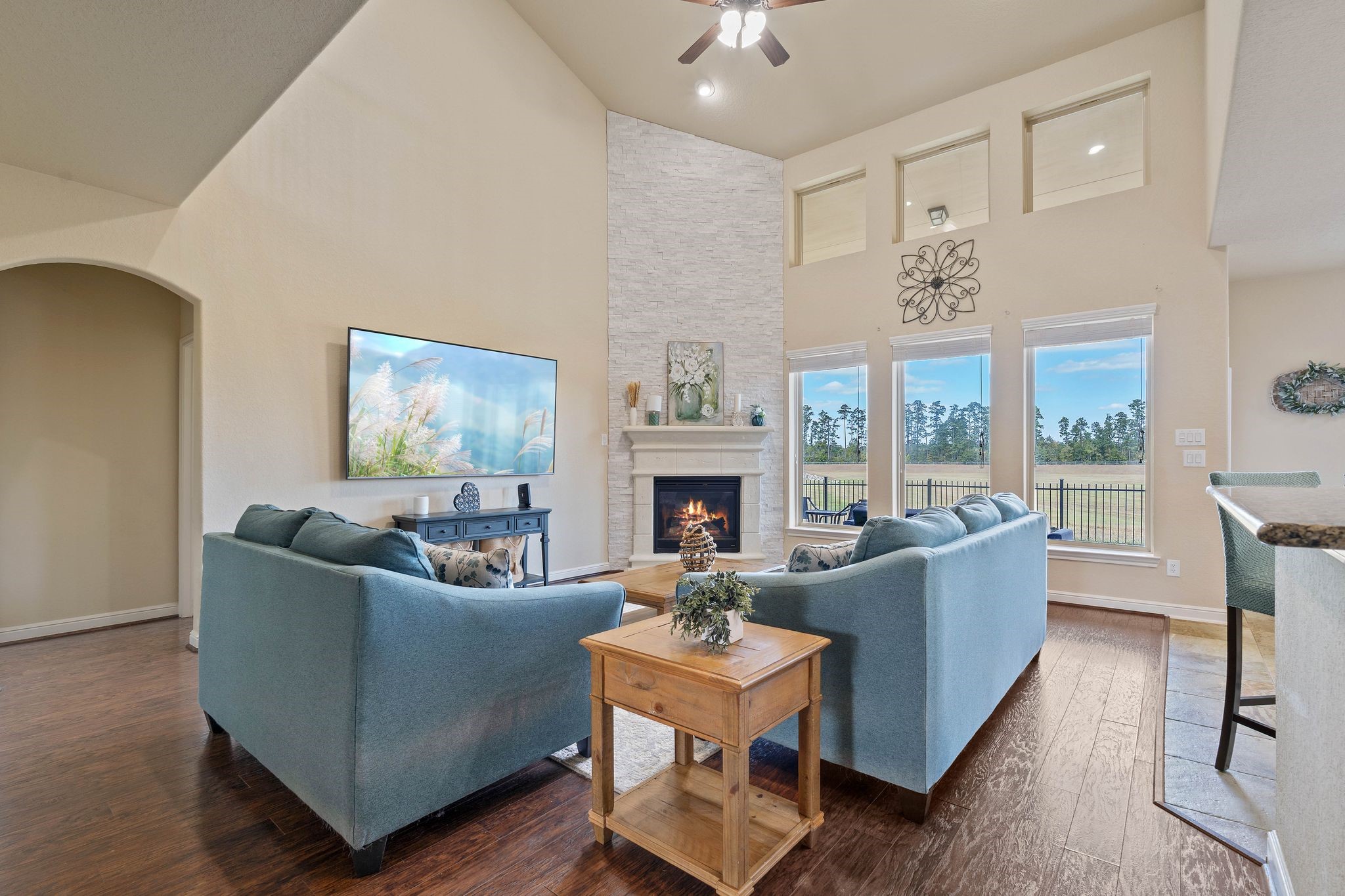 10114 North Whimbrel Circle Conroe, TX 77385 - Photo 10 of 50 a living room with furniture a large window and a fireplace