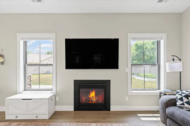 a living room with a fireplace and a flat screen tv