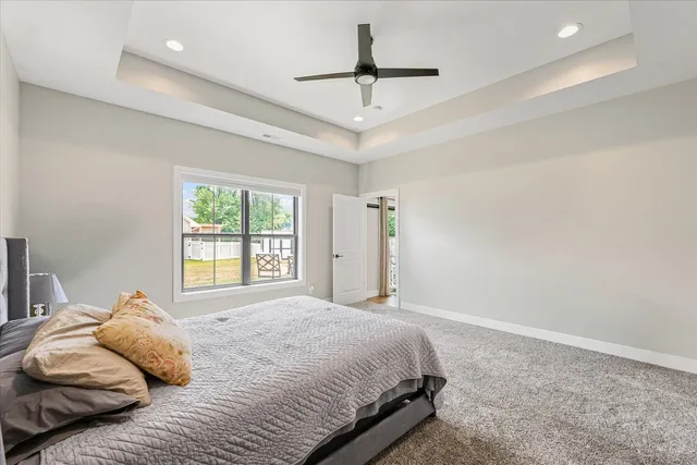 a bedroom with a large bed and a ceiling fan