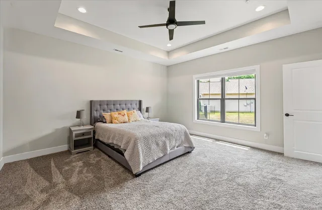 a spacious bedroom with a bed and a window