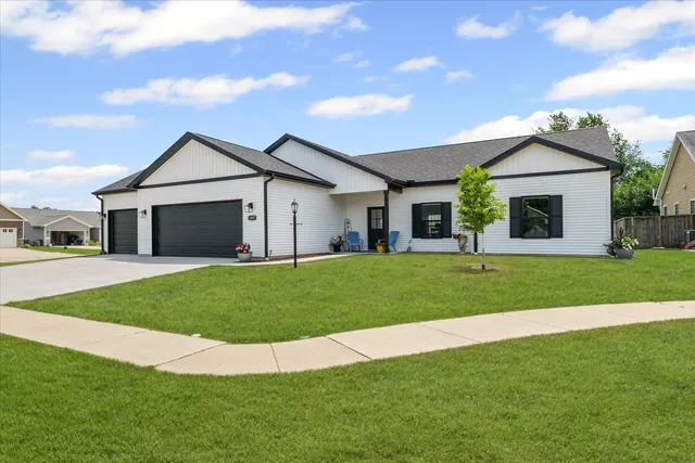 a front view of a house with a garden and yard