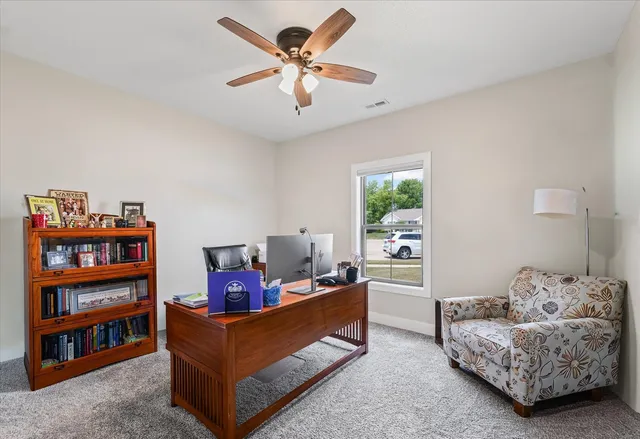 a living room with furniture and a book shelf