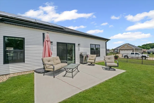 a view of house with swimming pool outdoor seating area and garden