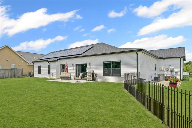 a front view of house with yard outdoor seating and barbeque oven