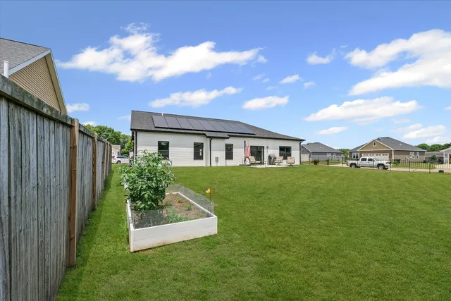 a front view of house with yard and green space