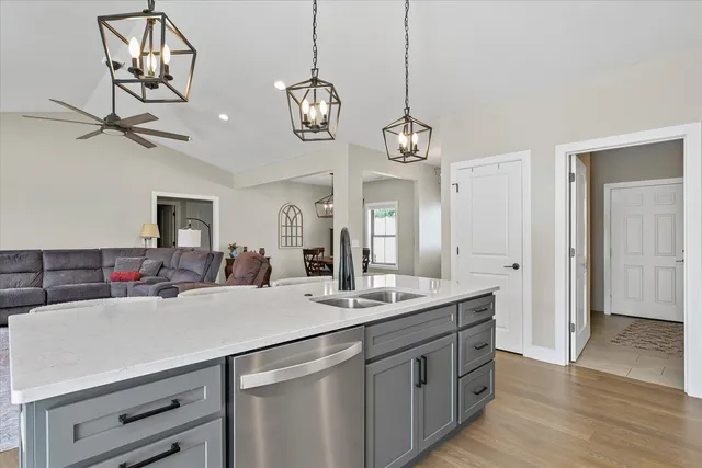 a kitchen with a sink and a chandelier