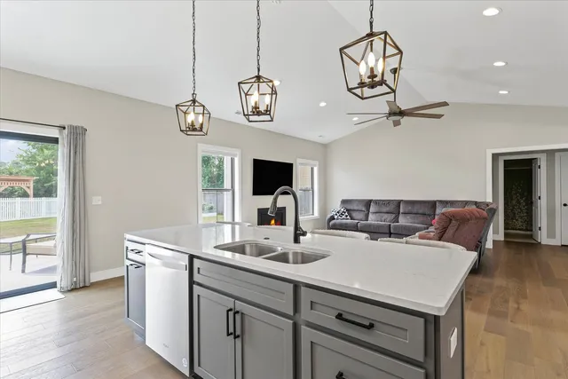 a view of a kitchen counter space a sink and a chandelier