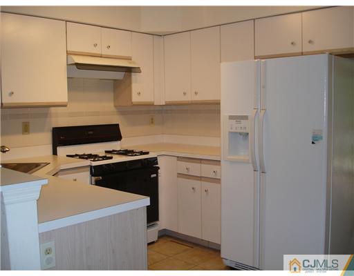 168 Salem Road North Brunswick, NJ 08902 - Photo 2 of 20 a kitchen with a cabinets and white appliances