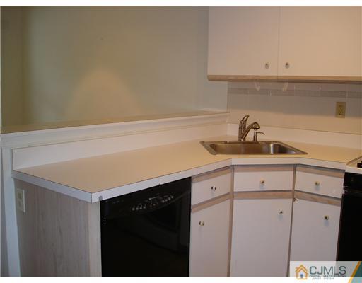 168 Salem Road North Brunswick, NJ 08902 - Photo 3 of 20 a kitchen with a sink and cabinets