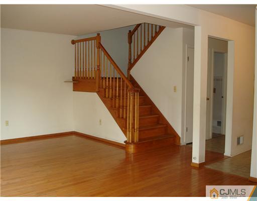 168 Salem Road North Brunswick, NJ 08902 - Photo 6 of 20 a view of a hallway with wooden floor and stairs