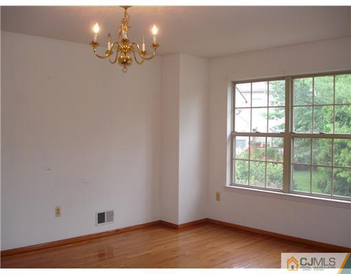 168 Salem Road North Brunswick, NJ 08902 - Photo 7 of 20 wooden floor in an empty room with a window