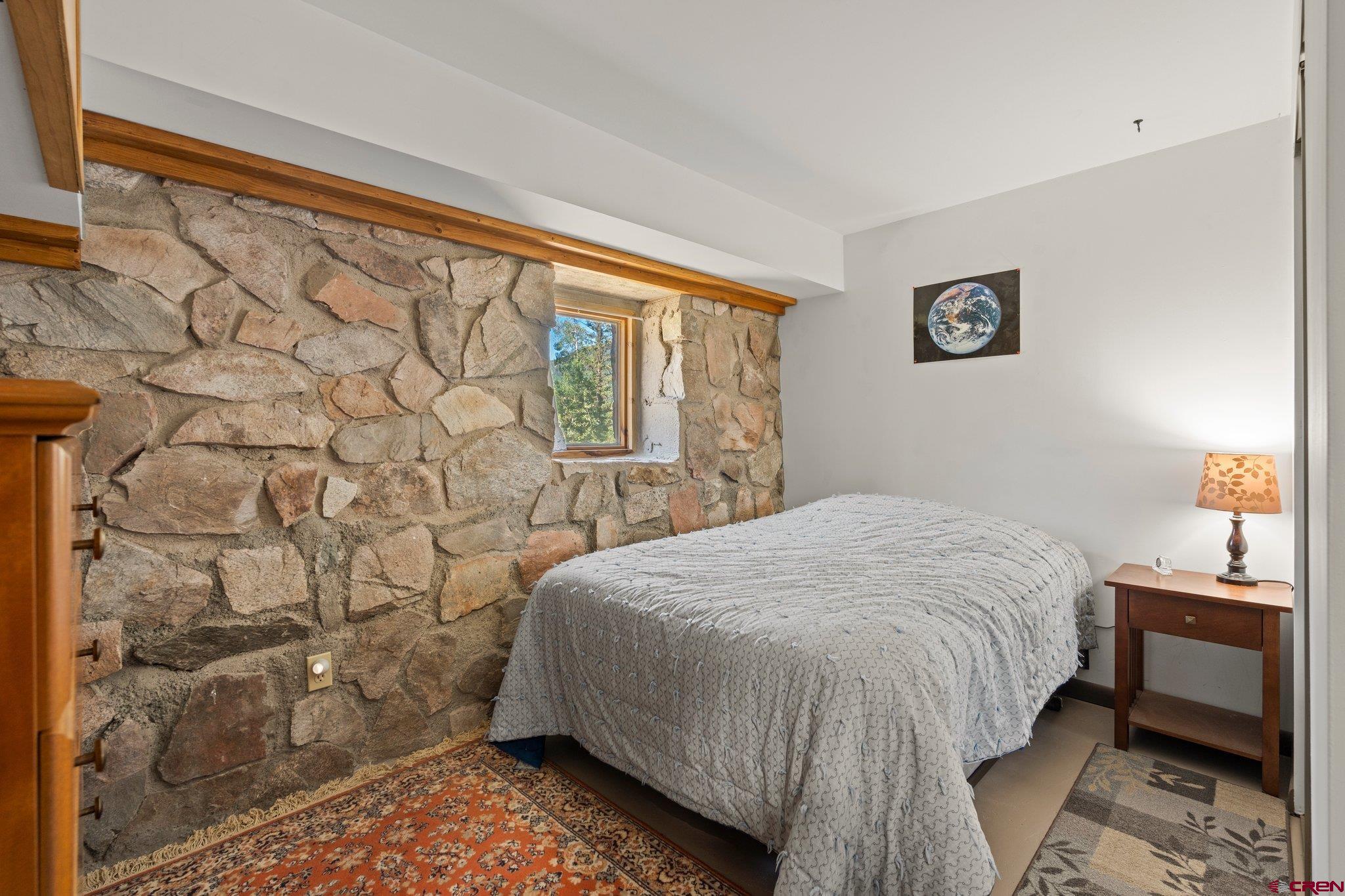 1389 County Road 240 Durango, CO 81301 - Photo 26 of 35 a bedroom with a bed and a window
