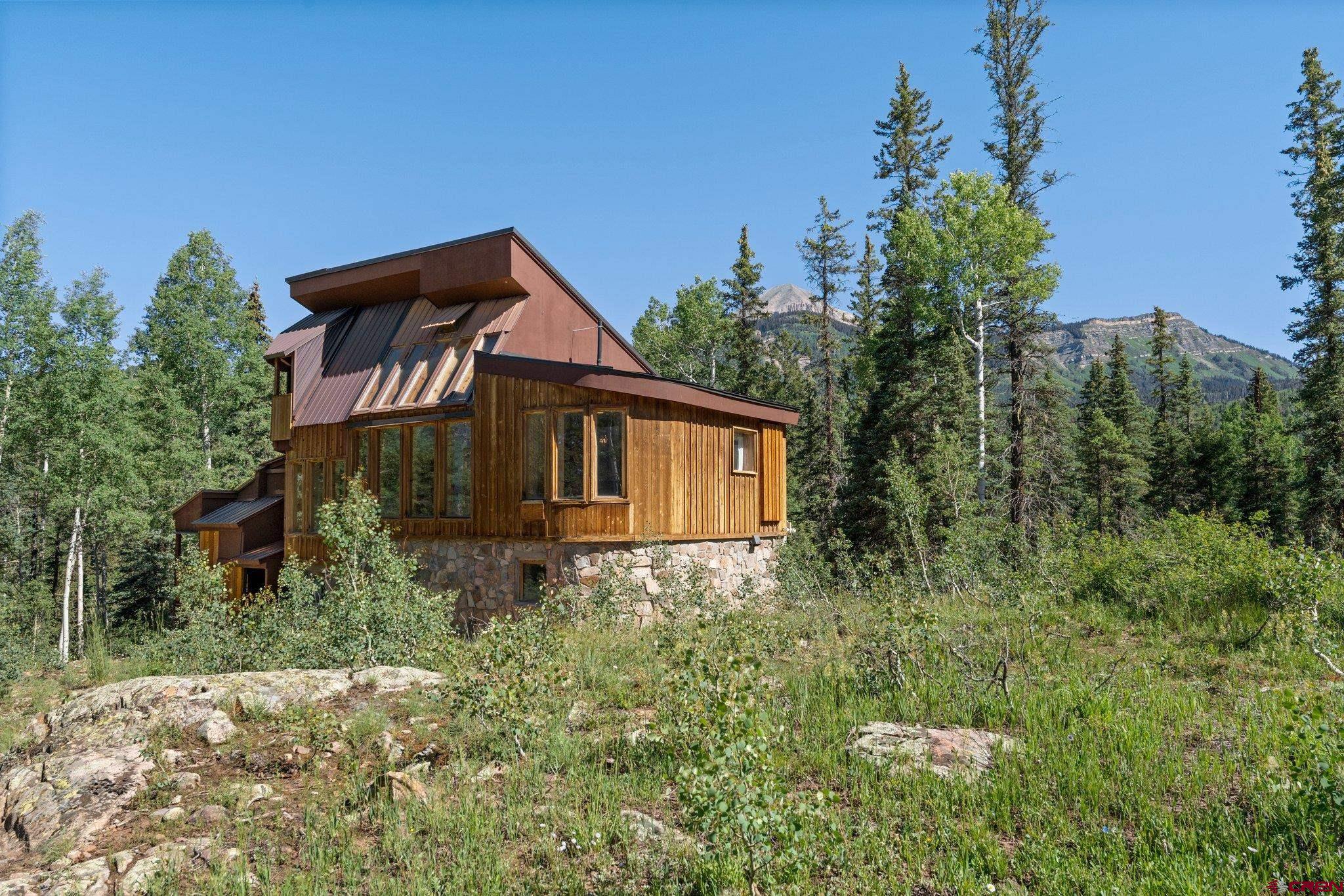 1389 County Road 240 Durango, CO 81301 - Photo 35 of 35 a house with trees in front of it