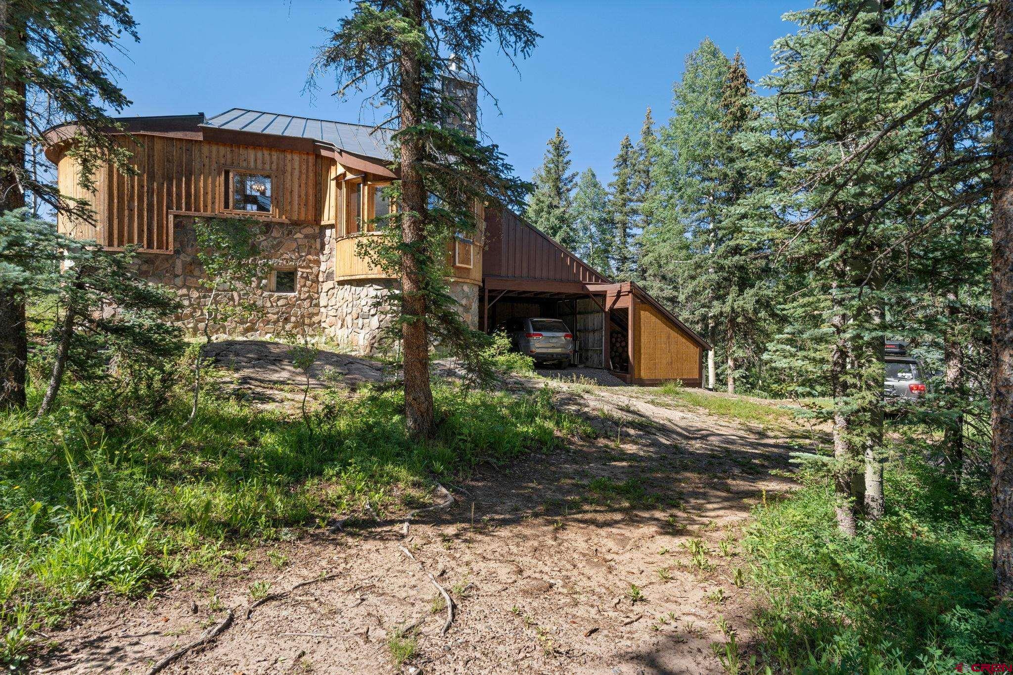 1389 County Road 240 Durango, CO 81301 - Photo 4 of 35 a front view of a house with garden