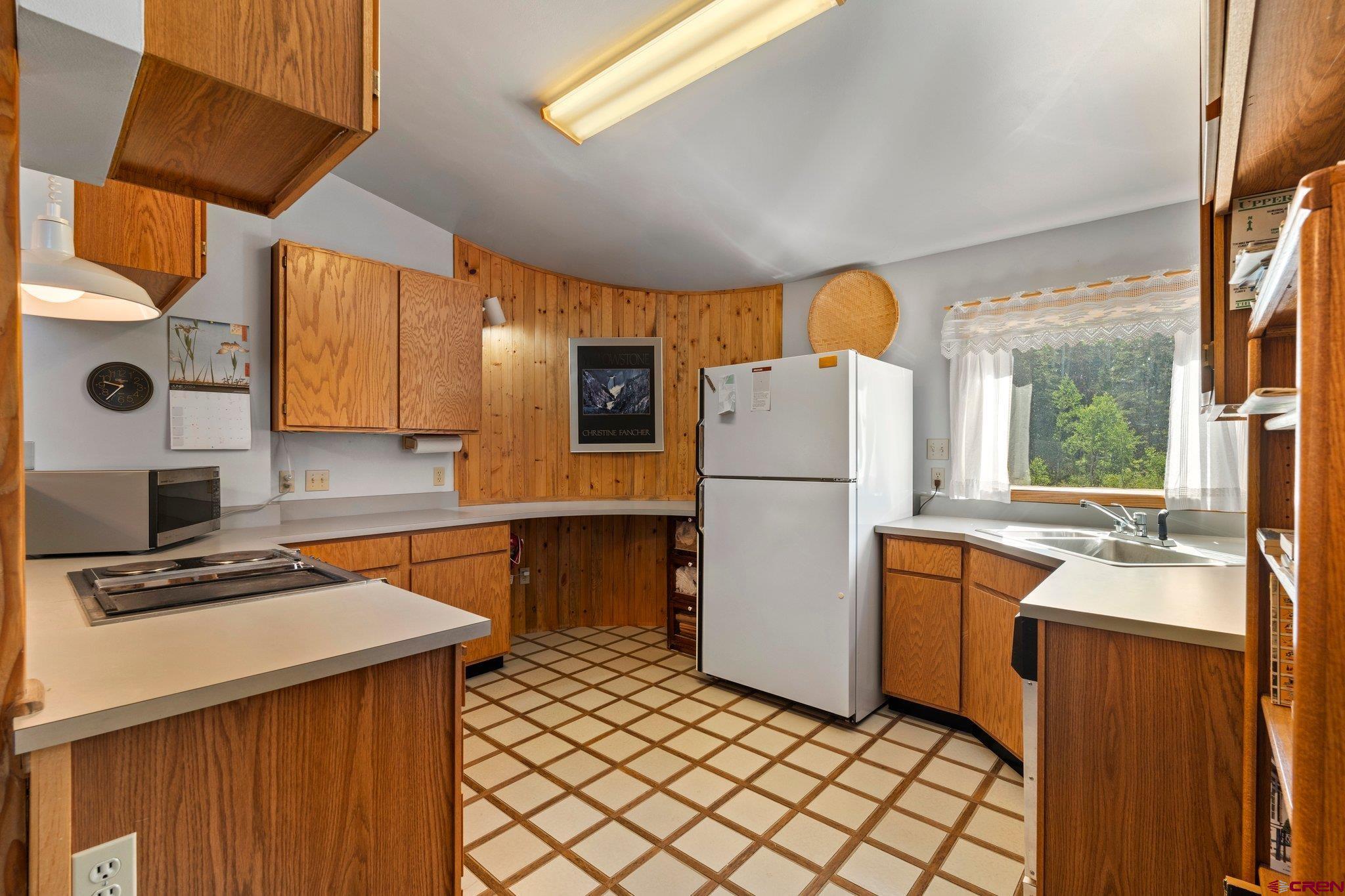1389 County Road 240 Durango, CO 81301 - Photo 6 of 35 a kitchen with a refrigerator a stove and a sink