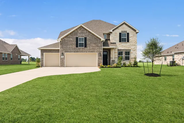 a front view of house with yard and green space
