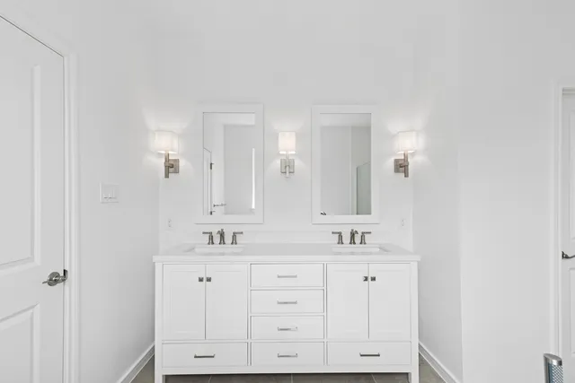 a view of an empty walk in closet with wooden floor