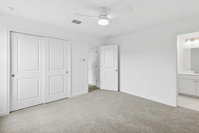 a kitchen with cabinets a sink and chairs