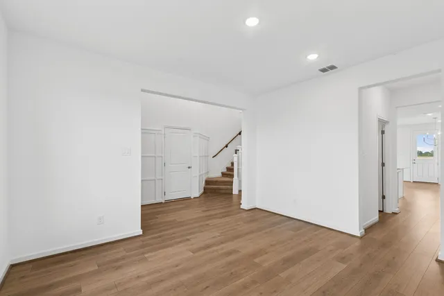 a view of empty room with wooden floor