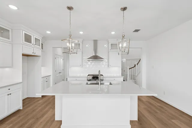 a kitchen with kitchen island a counter top space appliances and cabinets