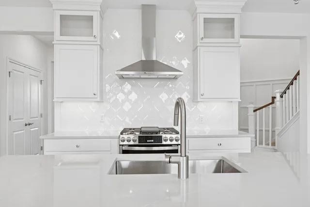 a kitchen with granite countertop a stove and a sink