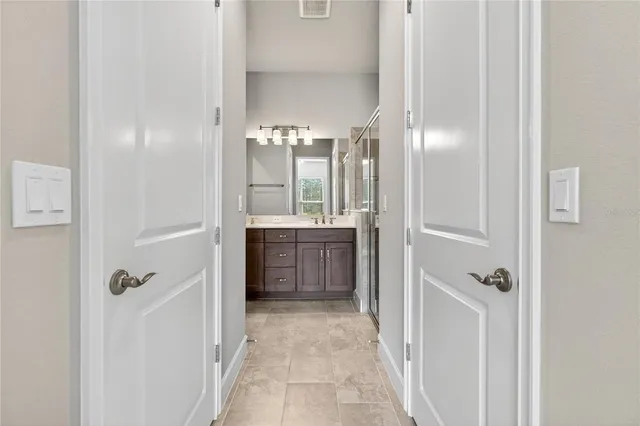 a bathroom with a double vanity sink a mirror and a shower