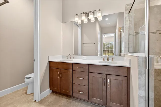 a bathroom with a double vanity sink and a mirror