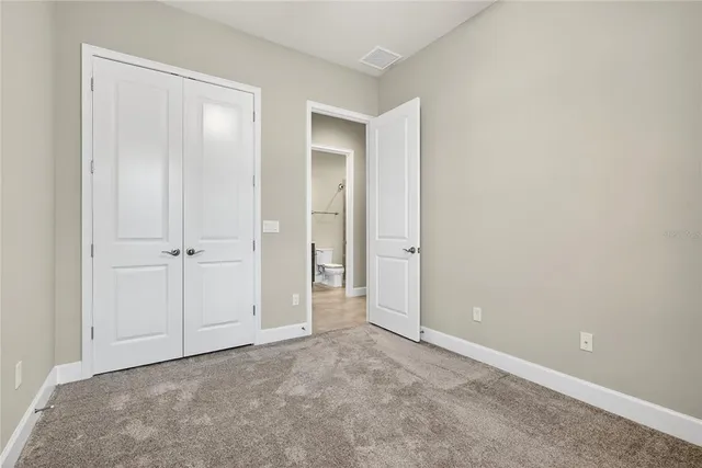an empty room with closet area