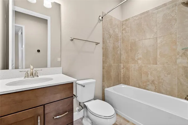 a bathroom with a sink a toilet a mirror a vanity and shower