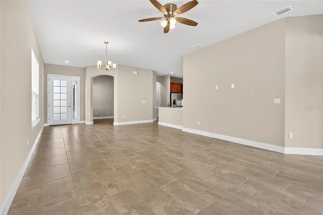 a view of a livingroom with a ceiling fan and window