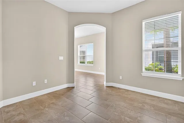 an empty room with windows and closet