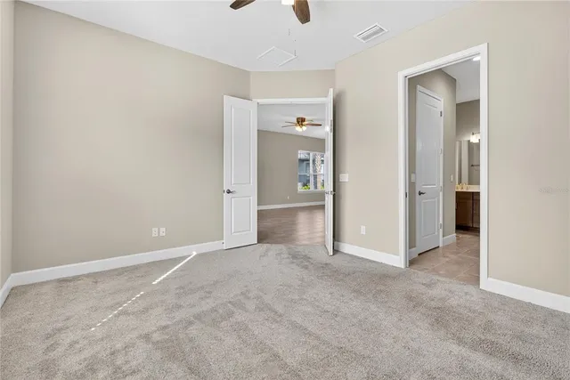 an empty room with fan and entrance