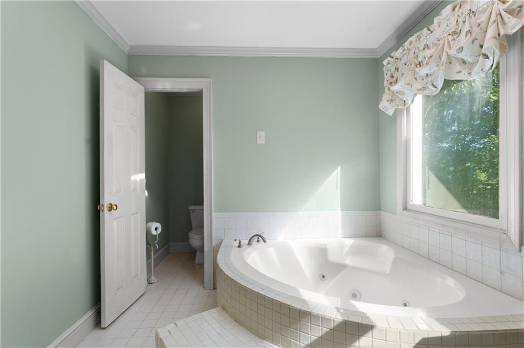 24 Commerce Row Northeast Cartersville, GA 30121 - Photo 20 of 37 a bathroom with a tub a double vanity sink and shower