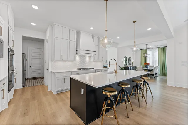 a kitchen with a table chairs refrigerator and microwave
