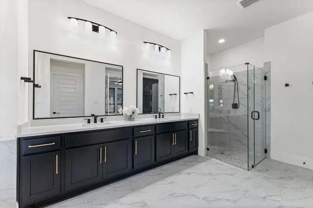 a bathroom with a double vanity sink mirror and double