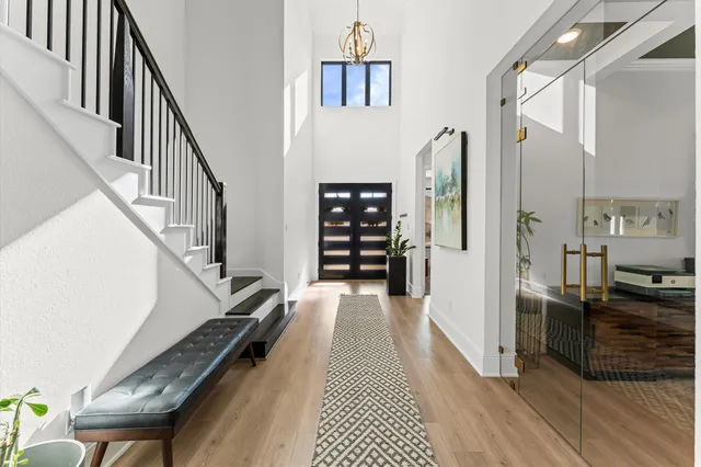 a view of a hallway with wooden floor and staircase