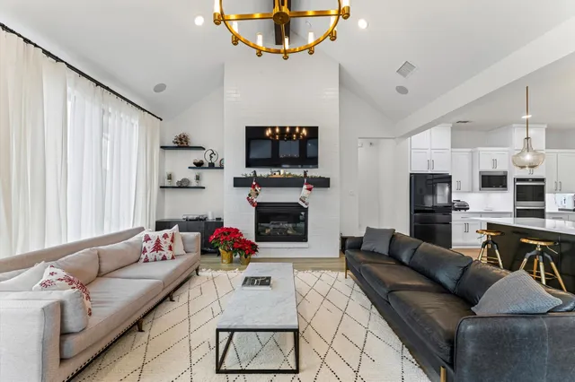 a living room with furniture a fireplace and a flat screen tv
